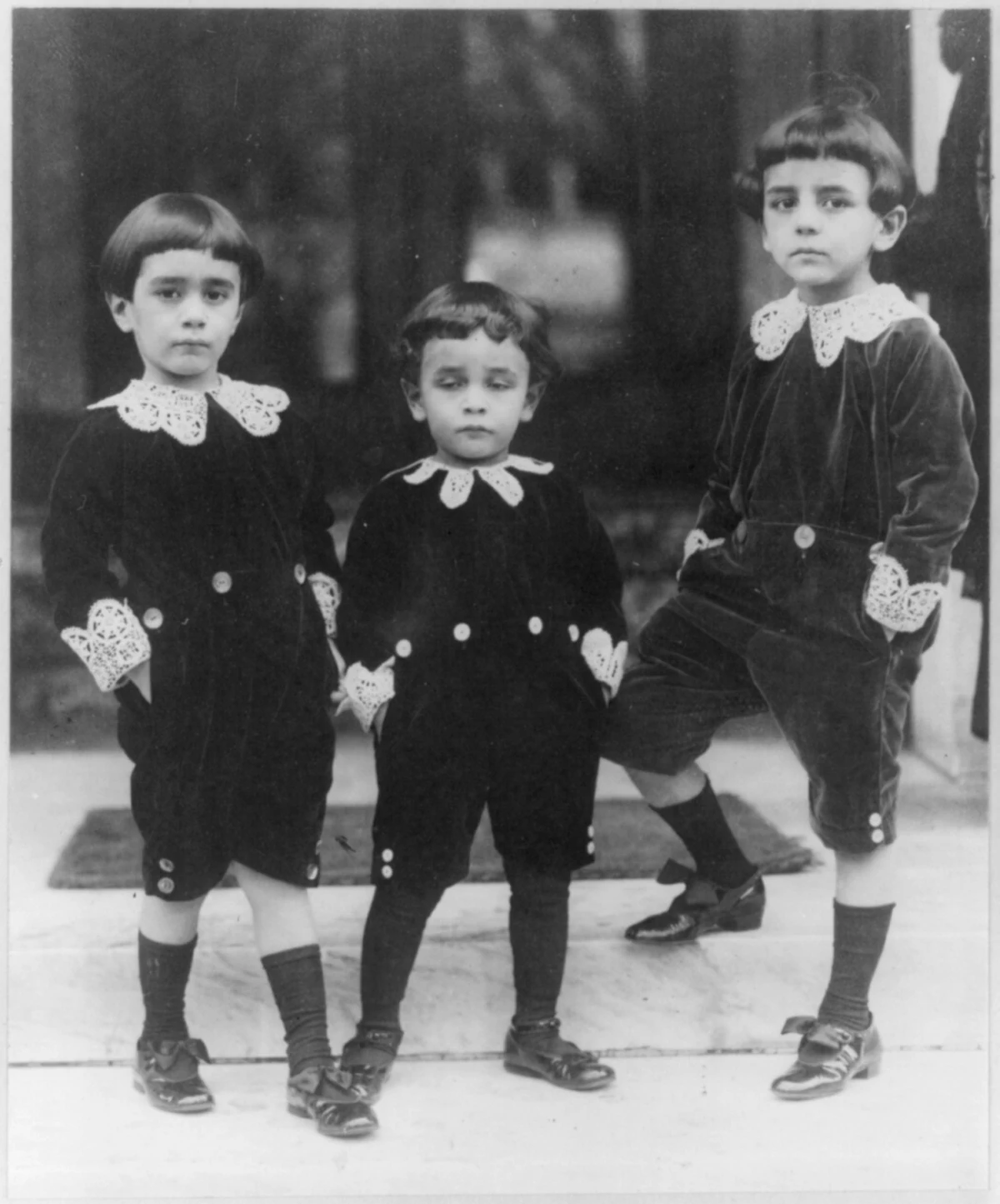 three children in velvet suits with lace collars